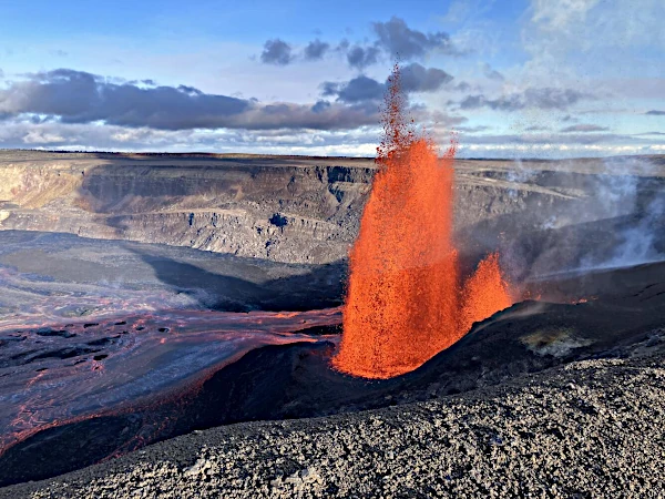 Volcanic eruption with red lava flows and gray ash plumes